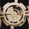 A close-up view of a wooden 3D puzzle, a perpetual calendar, being held by hands. Anteprima dell’immagine prodotto