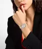 A woman wearing a watch on her wrist. Produktbild-Vorschau