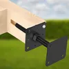 A close-up view of a wooden beam with a black metal post anchor attached, set against a blurred background of green grass and a blue sky. Podgląd zdjęcia produktu