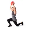 A man is performing a lunge exercise with a medicine ball overhead. Produktbild-Vorschau