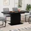 A dining room scene with a black extendable dining table and gray chairs. Podgląd zdjęcia produktu