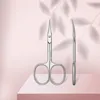 Two stainless steel cuticle scissors are displayed on a pink and white surface, with soft leaf shadows in the background. Náhled obrázku produktu