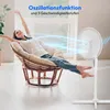 A woman relaxing in a chair while a fan blows air towards her. Produktbild-Vorschau
