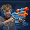A young person wearing safety glasses is holding a blue and orange Nerf Elite 2.0 Phoenix CS-6 blaster. Podgląd zdjęcia produktu
