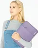 A young woman holding a laptop sleeve. Náhled obrázku produktu