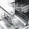 The interior of a dishwasher with racks and glasses. Produktbild-Vorschau