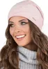 A woman wearing a pink beanie and a gray sweater. Produktbild-Vorschau