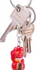 A close-up shot of a keychain with several keys and a red lucky cat charm. Produktbild-Vorschau