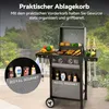 A gas grill is set up outdoors with food and drinks on it, and a close-up inset shows condiment bottles in a storage basket. Produktbild-Vorschau