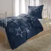 A bed with blue star-patterned bedding. Produktbild-Vorschau