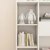 A white bookshelf with two Baymax figures on the top shelf and several books on the bottom shelf. Náhľad obrázku produktu