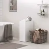 A modern bathroom scene with a bathtub, a white pedestal, a laundry basket, and decorative items. Podgląd zdjęcia produktu