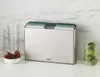 A set of cutting boards in a holder, along with some limes and chili peppers, on a kitchen counter. Anteprima dell’immagine prodotto