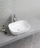 A white ceramic sink with a chrome faucet is shown on a gray marble countertop. Náhled obrázku produktu