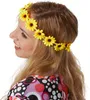 A woman wearing a flower crown and a colorful patterned dress. Produktbild-Vorschau