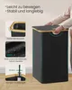 A person's hands are shown closing the lid of a black laundry basket with a wooden rim. The image also features close-up insets highlighting product features. Produktbild-Vorschau