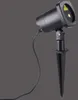 A black laser light projector with a stake for outdoor use, shown against a plain gray background. Anteprima dell’immagine prodotto