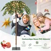 A family is posing in front of a house with a Christmas tree. Voir les images du produit