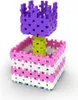 A 3D render of a building block toy flower pot with a flower on a white background. Podgląd zdjęcia produktu