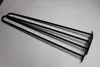Three black hairpin legs are laid out on a white surface. Produktbild-Vorschau