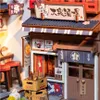 A miniature diorama of a Japanese wine alley shop, with detailed wooden structures, signage, and decorative elements. Náhled obrázku produktu