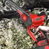 A hand holding a mini chainsaw cutting a tree branch. Produktbild-Vorschau