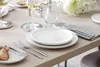 A table setting with plates, cutlery, and wine glasses. Náhled obrázku produktu