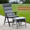 A gray reclining garden chair and ottoman are placed on a paved patio with a grassy lawn in the background. Produktbild-Vorschau