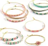 A collection of beaded bracelets arranged on a white background. Podgląd zdjęcia produktu