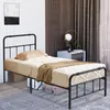 A black metal bed frame with a mattress and bedding in a bedroom setting. Náhled obrázku produktu