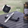 A power bank with an Apple Watch and charging cables on a table, with a lantern in the background. Produktbild-Vorschau