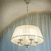A white chandelier hangs from the ceiling, with sheer white and blue curtains in the background. Anteprima dell’immagine prodotto