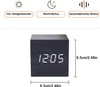 A black wooden cube alarm clock with a digital display showing the time. Produktbild-Vorschau