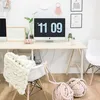 A home office setup with a desk, computer, and chairs, decorated with yarn balls and a blanket. Anteprima dell’immagine prodotto