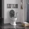 A toilet with a marble-patterned seat in a modern bathroom. Produktbild-Vorschau