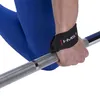 A person's hand wearing a black wrist strap with the HMS logo, gripping a silver barbell. The person is wearing blue leggings. Produktbild-Vorschau