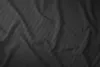 A close-up, abstract view of black fabric with subtle stripes and folds. Produktbild-Vorschau