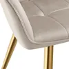 A close-up view of a beige upholstered chair with gold legs. Produktbild-Vorschau