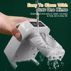 A hand is holding a white dumpling maker under running water, demonstrating its ease of cleaning. Produktbild-Vorschau
