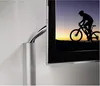 A close-up view of a TV screen and a cable management system. Podgląd zdjęcia produktu