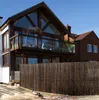 A bamboo privacy screen in a garden setting with a house in the background. Produktbild-Vorschau