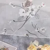 A close-up of a sheer curtain with a floral pattern. Produktbild-Vorschau