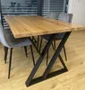 A dining table with metal legs and chairs in a room. Anteprima dell’immagine prodotto