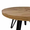 Close-up of a round wooden table with black metal legs. Náhled obrázku produktu