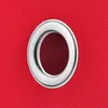 A close-up of a silver grommet on a textured red fabric. Produktbild-Vorschau