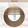 A close-up view of a furniture anti-tip bracket attached to a wooden surface, with a yellow arrow pointing to the surface. Voir les images du produit
