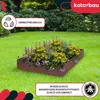 A wooden planter box filled with flowers and greenery, set on a lawn with a garden in the background. Produktbild-Vorschau