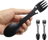 A hand holding a black multi-tool camping utensil that combines a spoon and a fork. Produktbild-Vorschau