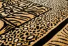 A close-up view of a rug with animal print patterns. Produktbild-Vorschau