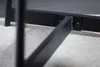 A close-up view of the black metal frame of a table, showing how a support leg is attached to the main frame with screws. Produktbild-Vorschau